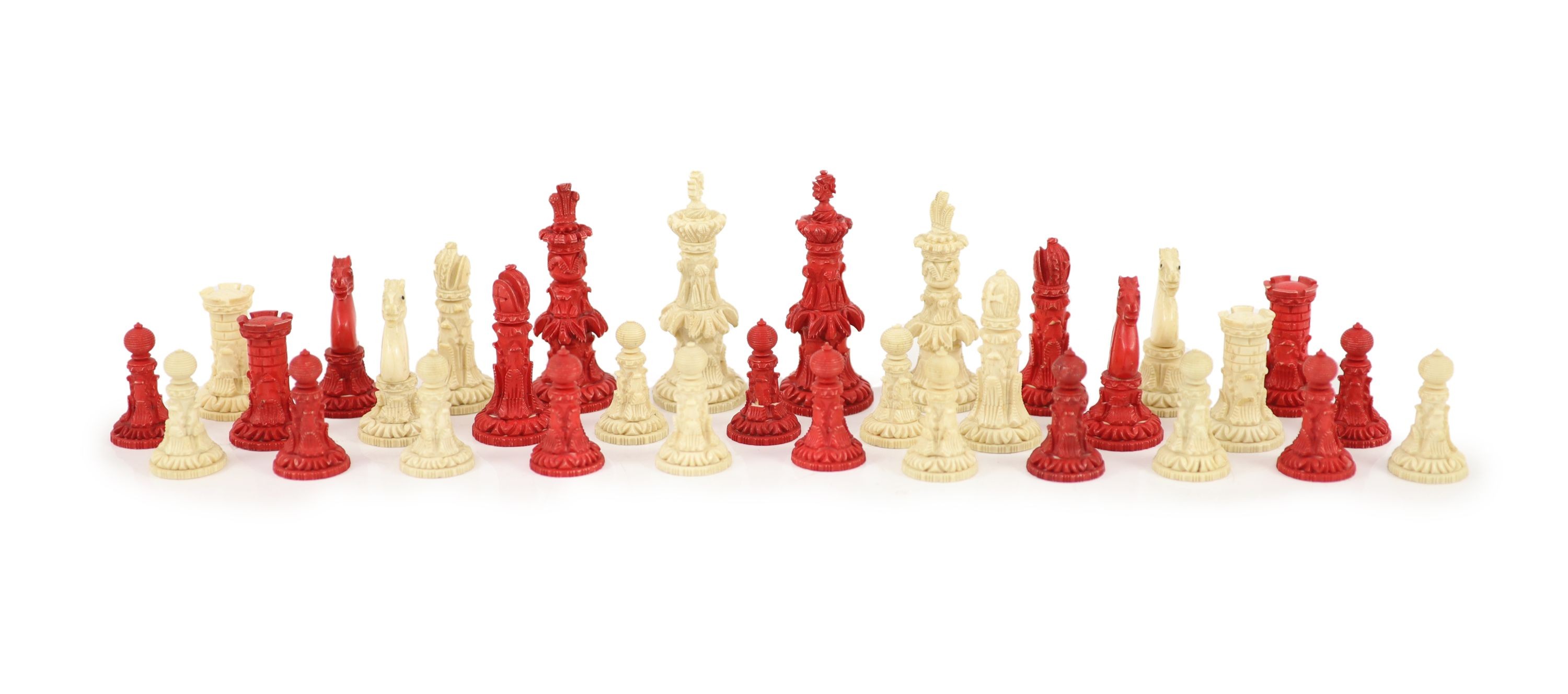 A 19th century Anglo-Indian white and stained bone chess set, with unusual carved palmate decoration, Kings 9.5cm.